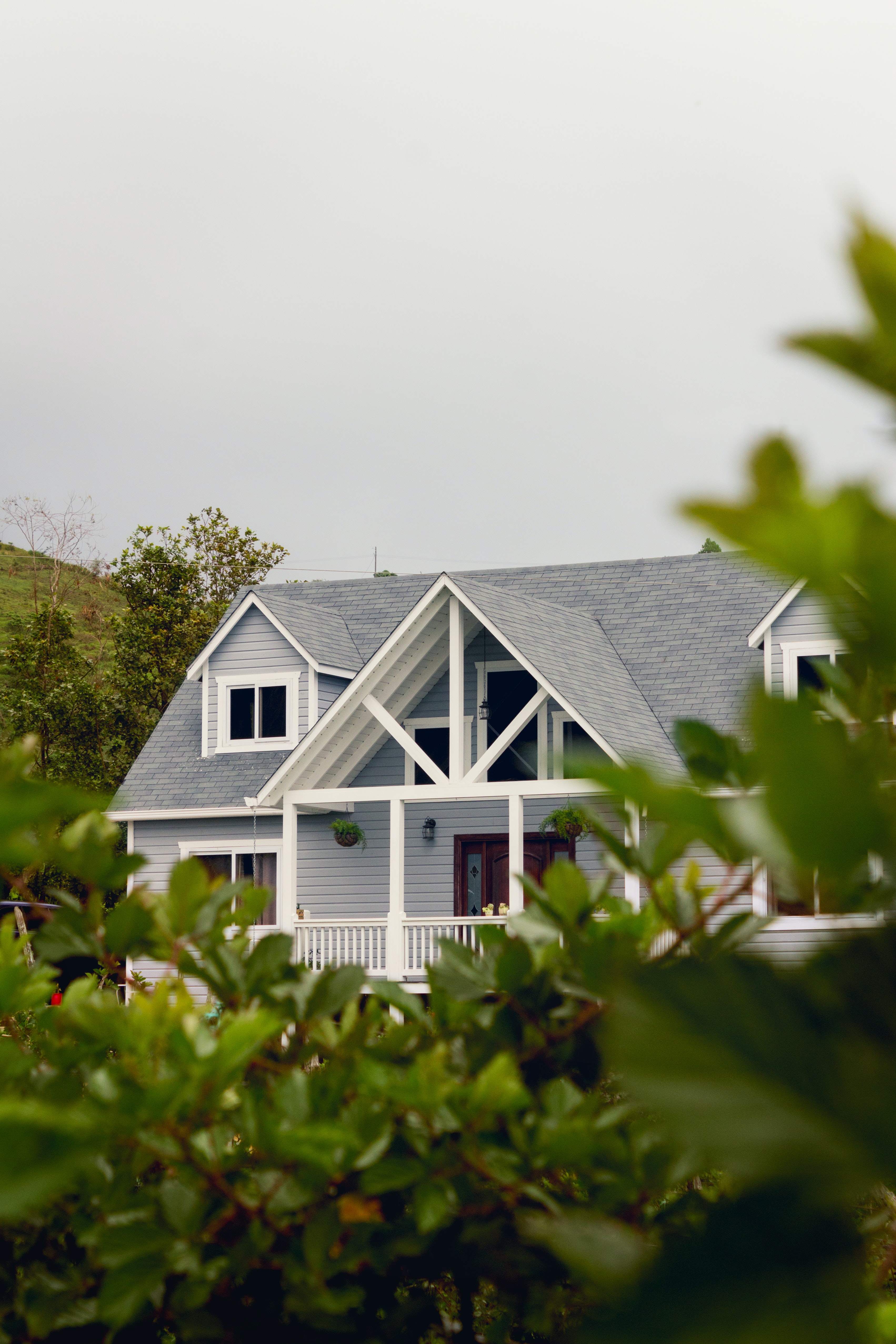 white home with gray, shingled roof